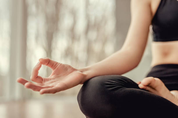 istock Peaceful woman practicing meditation in lotus pose 1178672374
