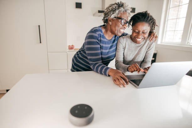 istock Grandma and granddaughter using laptop in the kitchen 1178672438