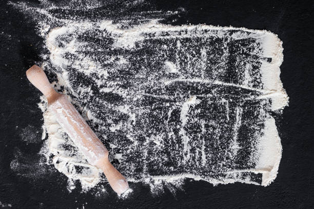 istock Rolling pin and white flour on a dark background 1178674287