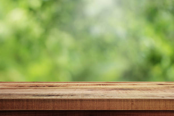 istock Blurred abstract green and wooden table background. 1178675011