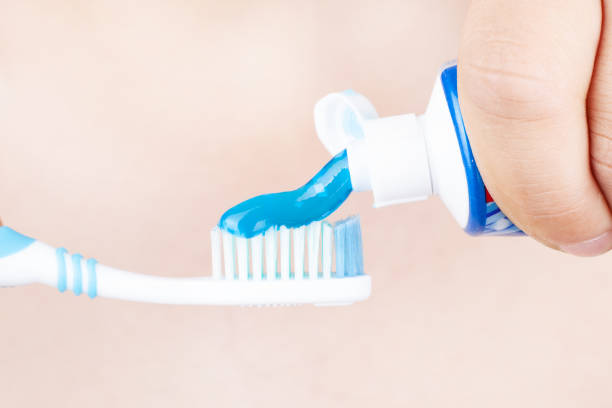 istock toothpaste is applied to the toothbrush,concept: tooth brushing 1178677614