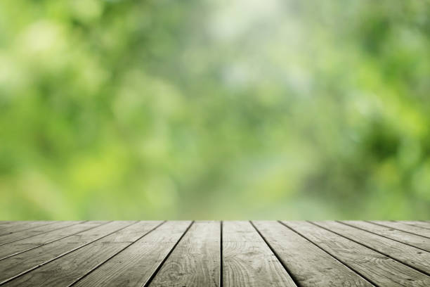 istock Blurred abstract green and wooden table background. 1178679206