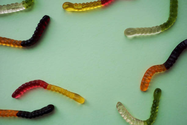 istock Gummy worms on green background 1178679948