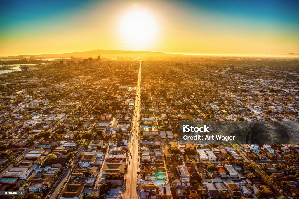 Long Beach California at Dusk The sun nearing the horizon over Long Beach, California lining up with one of the main streets in the city illuminating the pavement shot from about 1000 feet overhead. Long Beach - California Stock Photo