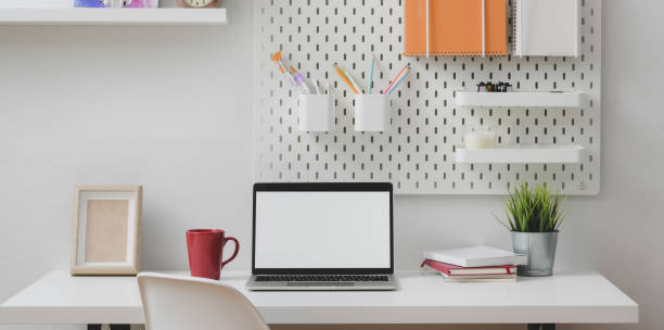 istock Minimal home office with open blank screen laptop computer with stationary 1178680222