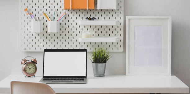 istock Modern white workplace with open laptop computer and mock up frame with stationary 1178680242