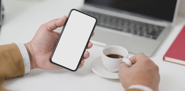istock Businessman holding blank screen smartphone while drinking a cup of coffee 1178680255