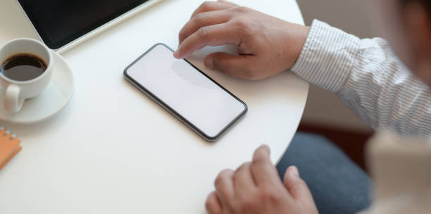 istock Young professional businessman looking for information on blank screen smartphone 1178680300