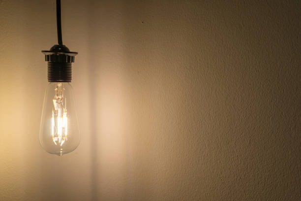 istock Glowing light bulb hang on wall and copy space for text, idea concept 1178682066