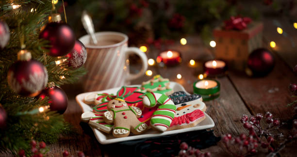 Christmas gingerbread man, cookies and hot chocolate on an old wood background Christmas gingerbread man cookies, iced cookies and hot chocolate. Christmas Tree Cookie stock pictures, royalty-free photos & images