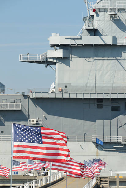 istock Yorktown aircraft carrier with American Flags 117869202