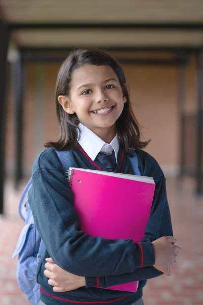 istock Happy girl at the school holding a notebook 1178693889
