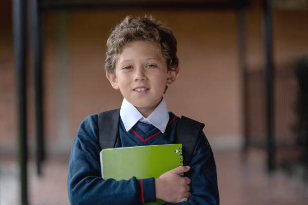 istock Portrait of a boy at the school holding a notebook 1178693937