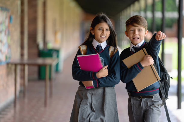 istock Young students at the school pointing the way to the classroom 1178694022