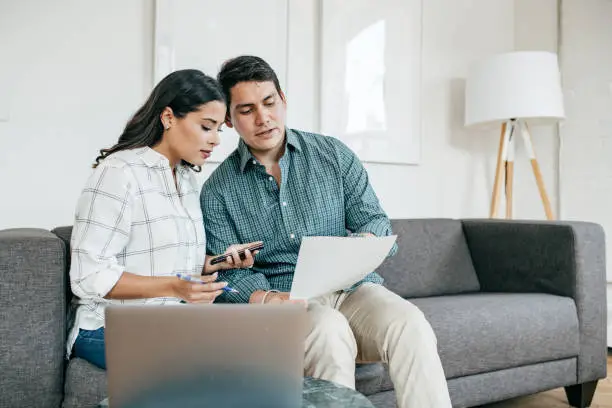 Photo of Couple looking on bank statements