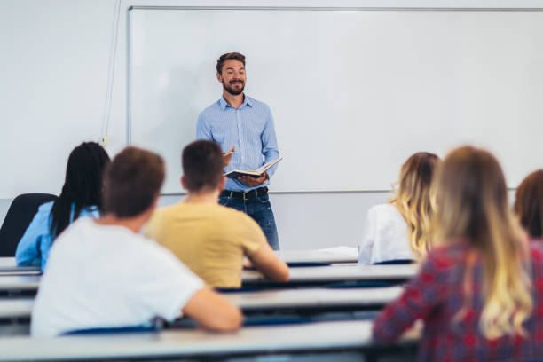 teacher giving a lecture in amphitheatre. - teaching seminar presentation classroom imagens e fotografias de stock