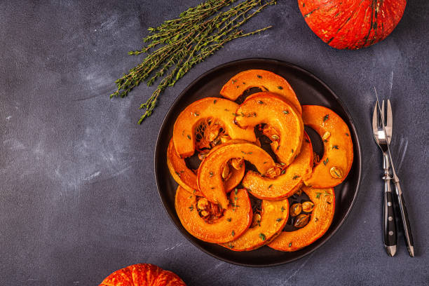 istock Baked slices of pumpkin on a dark background 1178700967