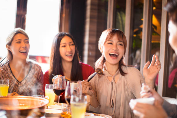istock happy young friends enjoy dinner in hot pot restaurant 1178702213