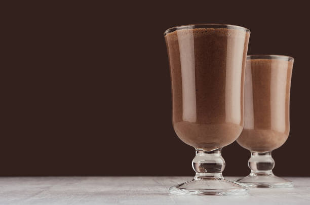 istock Christmas beverage - hot chocolate in transparent goblet on elegant dark brown interior, copy space. 1178702498