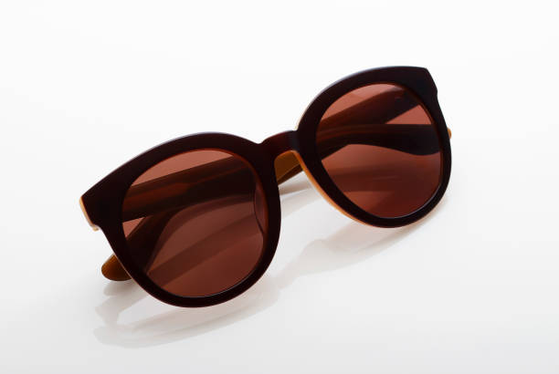 istock Brown sunglasses isolated on light glossy background close-up 1178706690