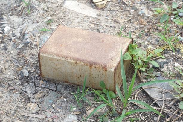 close up old dirty rusty bucket on dry crack soil
