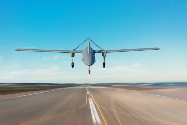 istock Unmanned military drone landing on runway military base. 1178707573