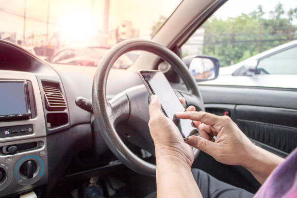 istock man hands using mobile phone in car during traffic jam on the road 1178708510