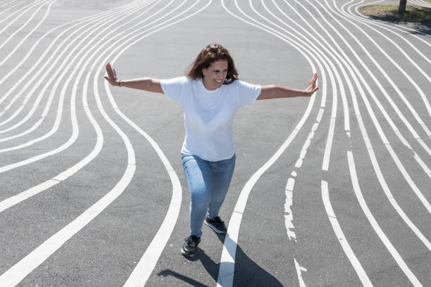 Portrait of woman showing her strength to separate some lines. Creative and strong concept. stock photo