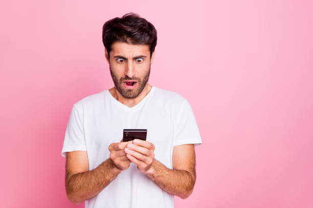 istock Portrait of impressed amazed emotion middle eastern man use his smartphone look read feedback feednews comments scream wow omg wear style summer outfit isolated over pink color background 1178713018