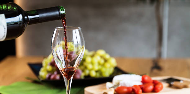 waiter pouring red wine into wineglass. - wineglass red wine wine liquid imagens e fotografias de stock