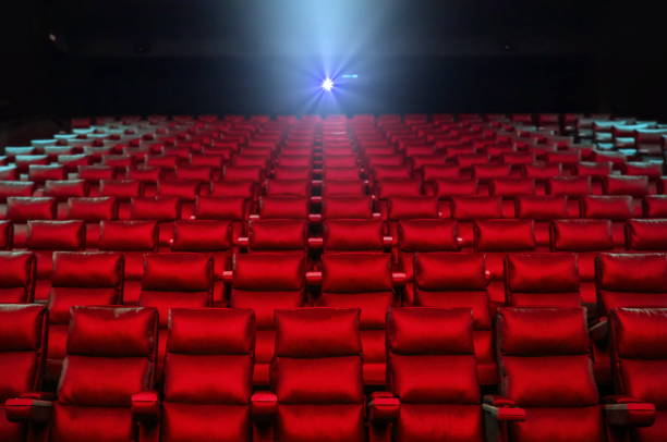 istock Cinema seats with projector bright lights 1178714184