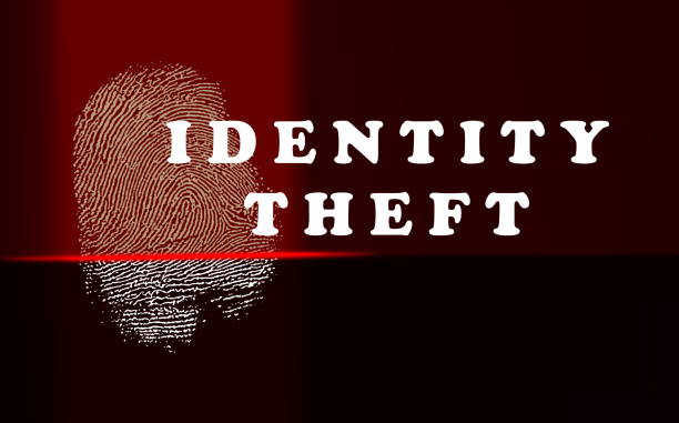 親指のプリントと赤いスキャナライトを使用したアイデンティティ盗難の概念 - identity theft ストックフォトと画像