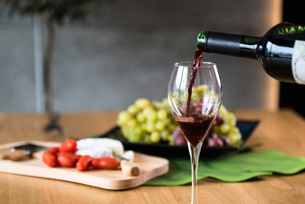 istock Waiter pouring red wine into wineglass. 1178714188