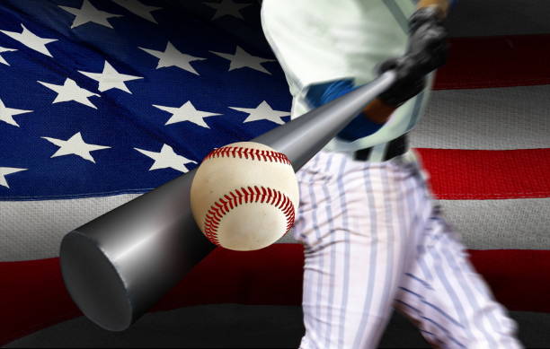 istock Baseball player hitting ball with American flag in background 1178714232