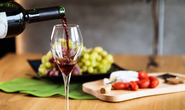 istock Waiter pouring red wine into wineglass. 1178714265