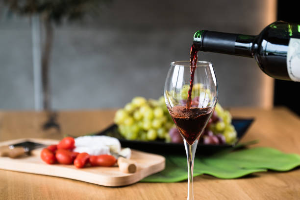 istock Waiter pouring red wine into wineglass. 1178714312