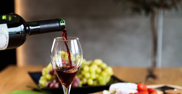 istock Waiter pouring red wine into wineglass. 1178714495