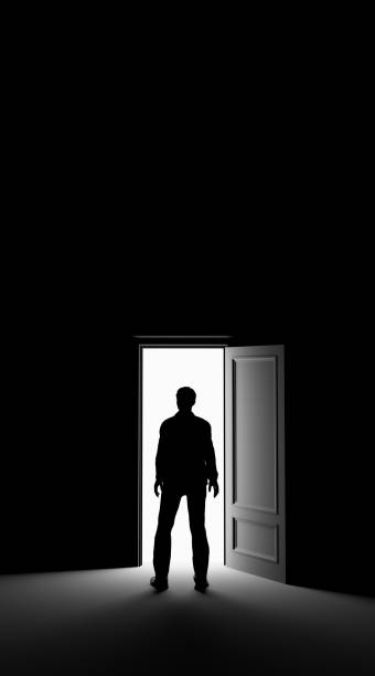Silhouette of a man standing in a dark room lit by bright light. 3d rendering