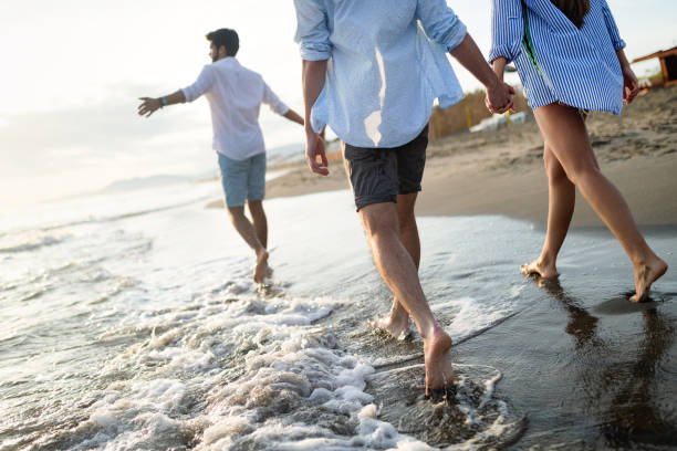 istock Happy cheerful couple having fun on a tropical beach at sunset 1178720861