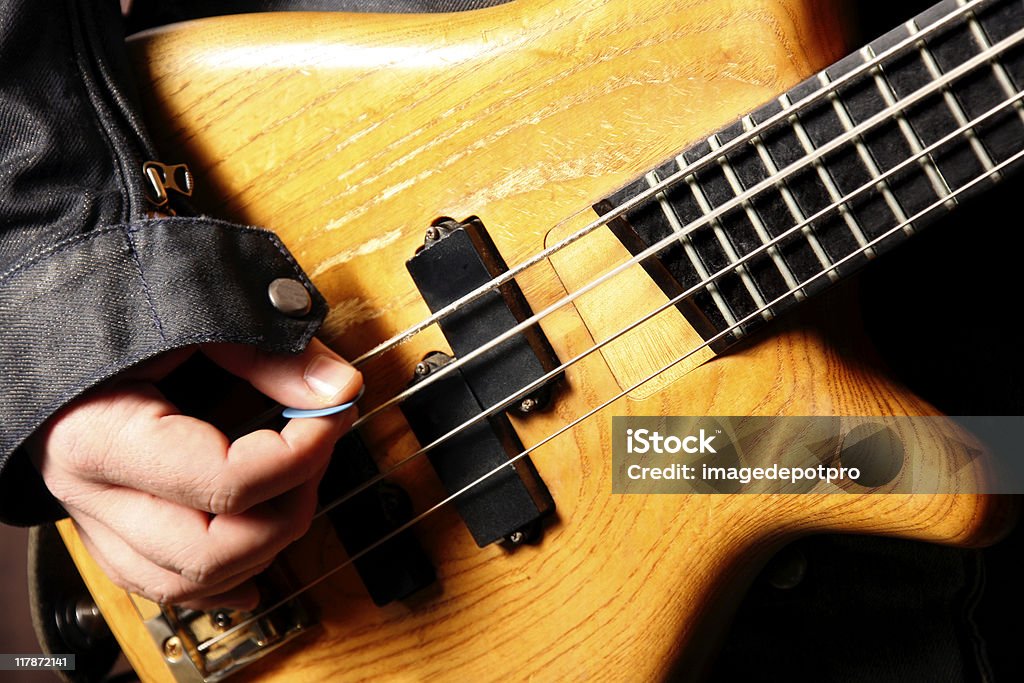 bass guitarist playing close up shot of rock and roll bass guitarist. Stage - Performance Space Stock Photo