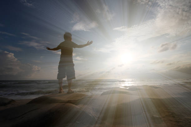istock Young man standing on the rock absorb the sunrise power 1178721733