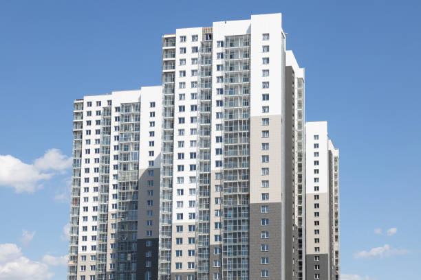 istock High white-grey multi-family dwelling building against blue sky 1178722082