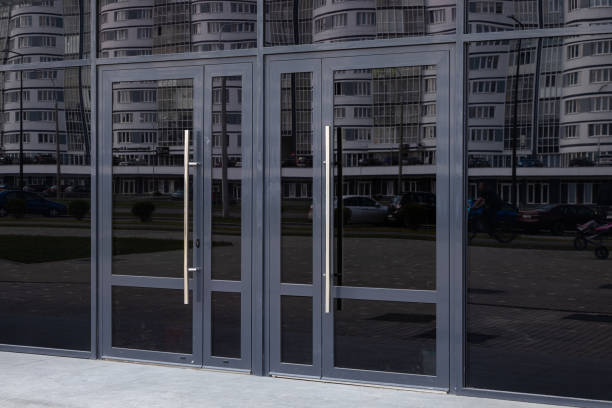 istock Black glass doors reflecting block of flats standing in the opposite side 1178722087