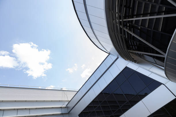 Ground view of modern building with black tinted windows against sky