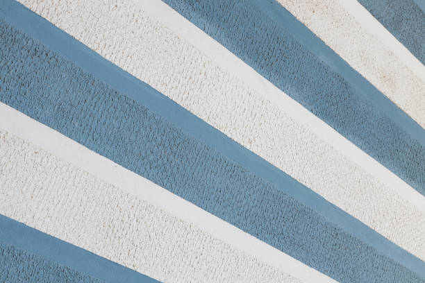 istock Diagonal view of blue and white parget striped wall background. Sharp surface. 1178724101