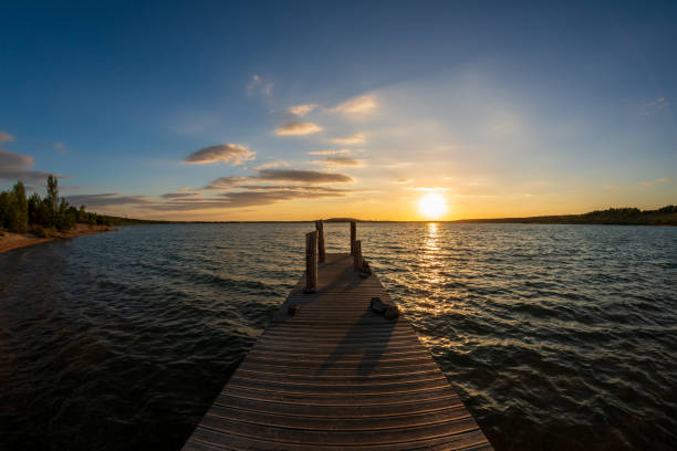 istock Orange summer sunset at a lake behind a jetty 1178724194