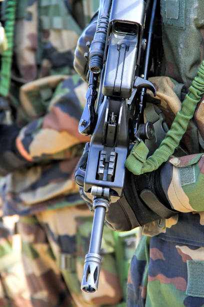 Ready for combat: Close up of a soldier with a gun