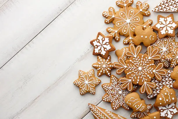 Photo of Christmas gingerbread cookies set on white planks