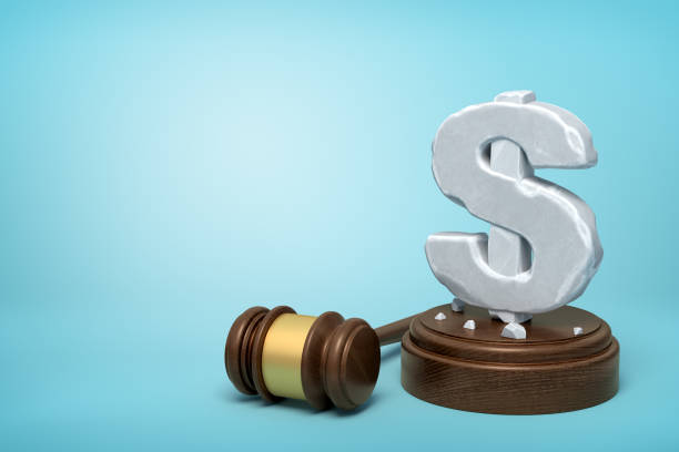 3d rendering of hefty stone dollar symbol standing on wooden sounding block with gavel beside on light-blue background with copy space. - employment issues law gavel legal system imagens e fotografias de stock