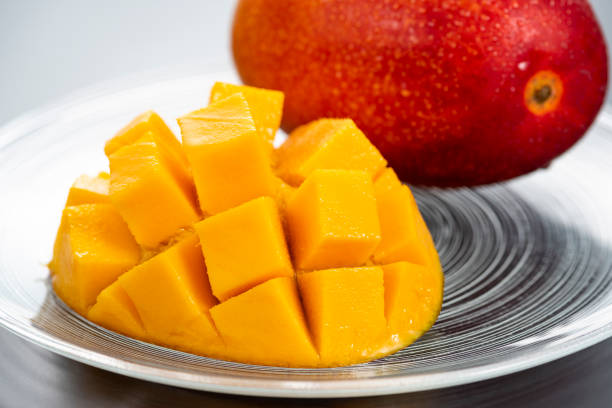 Close-up of mango on a glass plate Close-up of mango on a glass plate miyazaki prefecture stock pictures, royalty-free photos & images